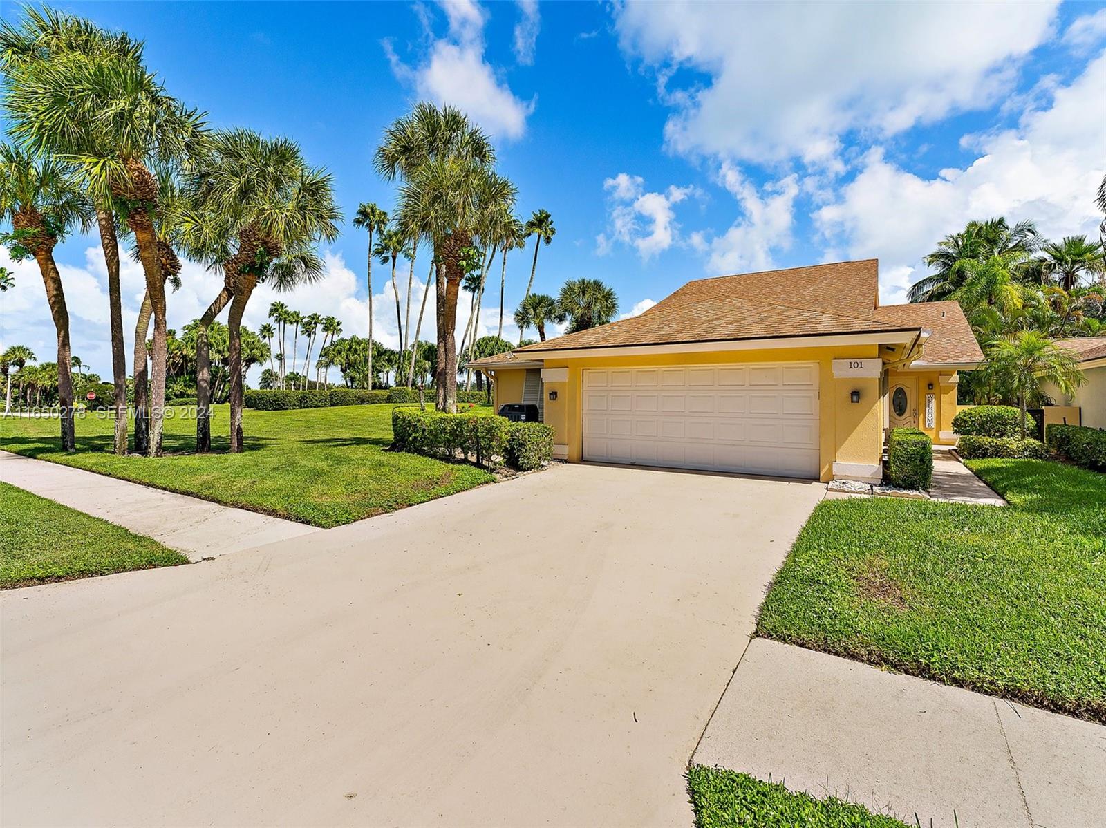 101 Sand Pine Drive, Unit 101 Jupiter, FL 33477 - Photo 6 of 47 a view of a yard in front of a house