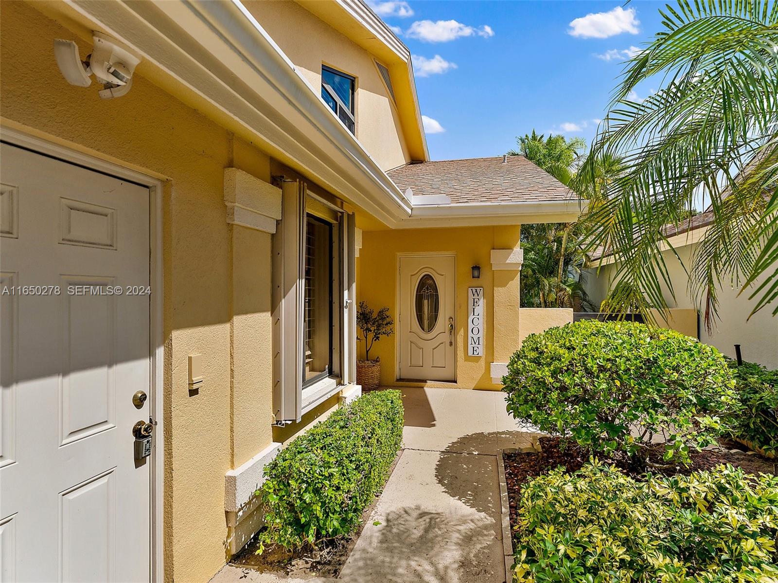 101 Sand Pine Drive, Unit 101 Jupiter, FL 33477 - Photo 7 of 47 a front view of a house with a yard