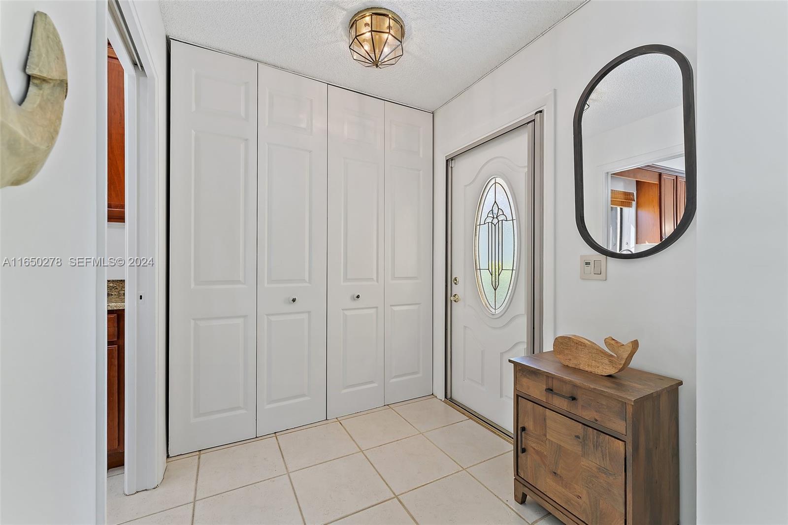 101 Sand Pine Drive, Unit 101 Jupiter, FL 33477 - Photo 10 of 47 a bathroom with a sink a mirror and a shower