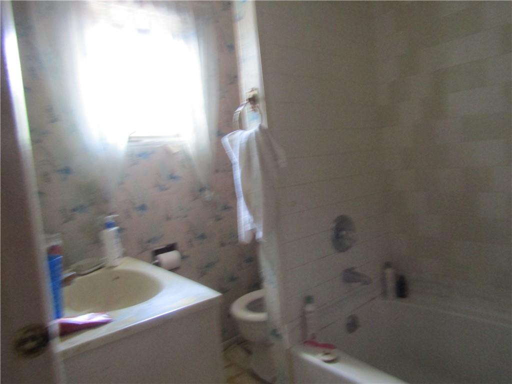 174 Juniata Road Dunbar, PA 15431 - Photo 7 of 12 a bath tub sitting next to a white toilet and sink