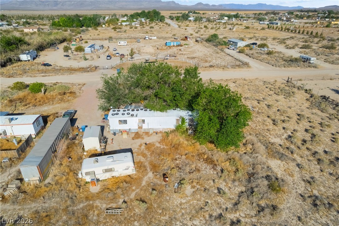 2350 Shawnee Street Sandy Valley, NV 89019 - Photo 25 of 38 Aerial view of property's location with a mountain backdrop, a desert landscape, and rural landscape