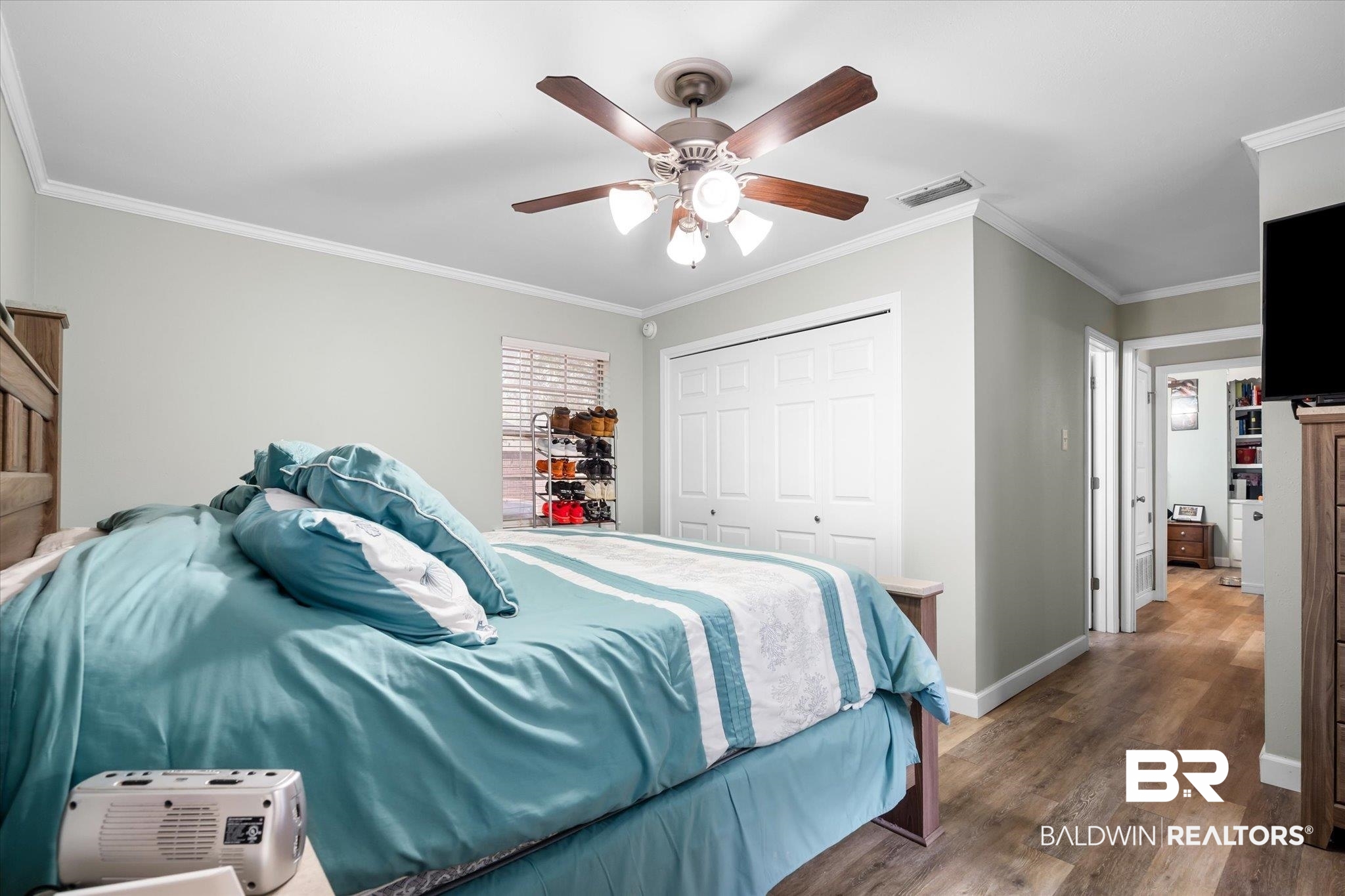 9987 Downing Street Semmes, AL 36575 - Photo 11 of 20 Bedroom with ornamental molding, a closet, ceiling fan, and dark hardwood / wood-style floors