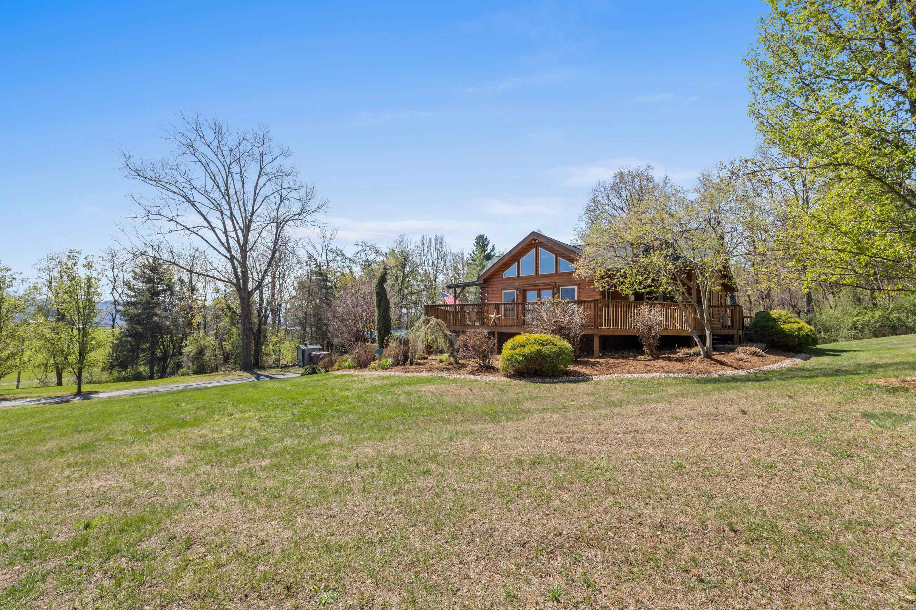 115 Spring Crossing Lane Steeles Tavern, VA 24476 - Photo 12 of 74 a view of a house with a yard and sitting area