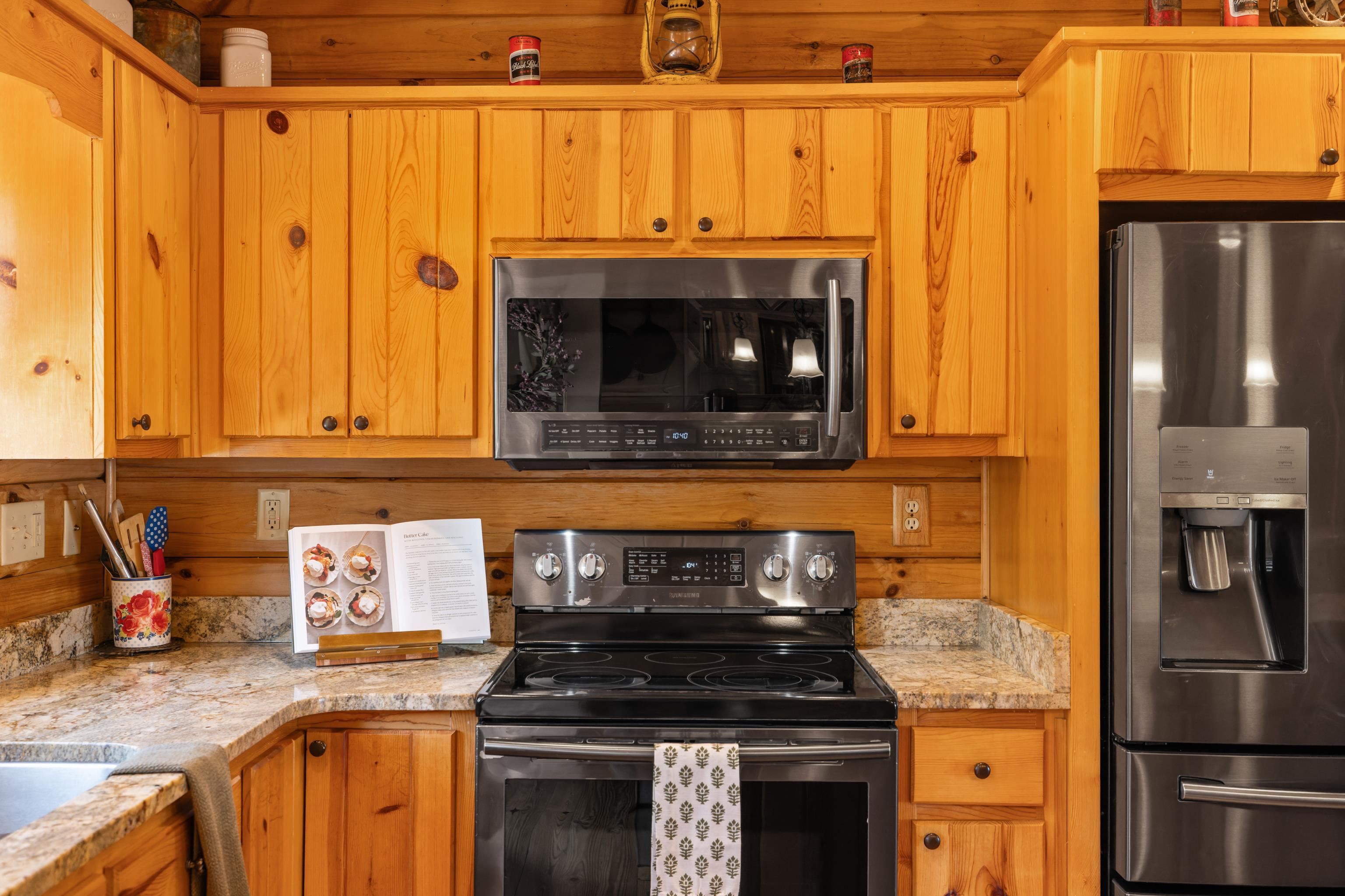 115 Spring Crossing Lane Steeles Tavern, VA 24476 - Photo 30 of 74 a kitchen with granite countertop a stove and a refrigerator