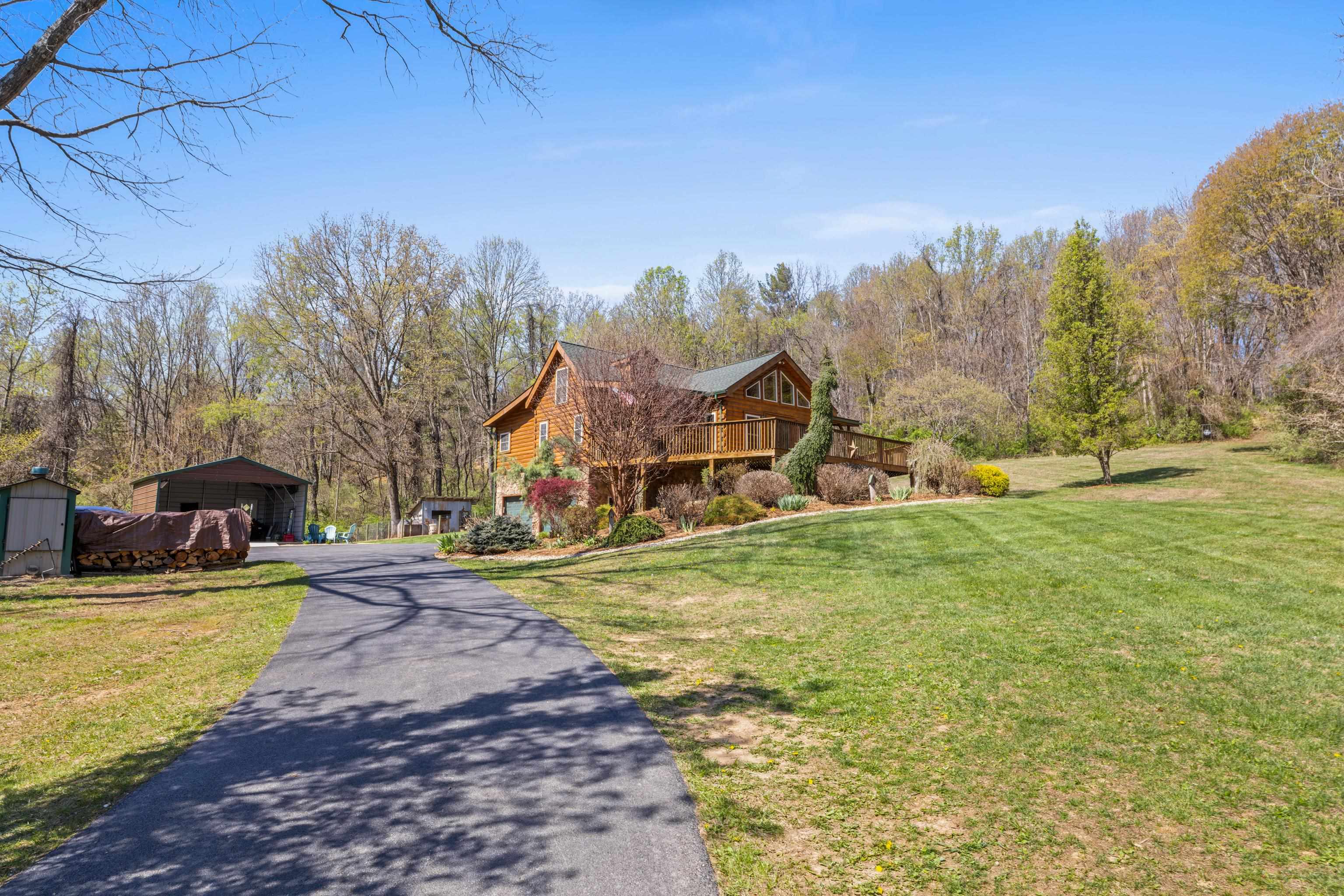 115 Spring Crossing Lane Steeles Tavern, VA 24476 - Photo 5 of 74 a view of a house with a big yard and large trees
