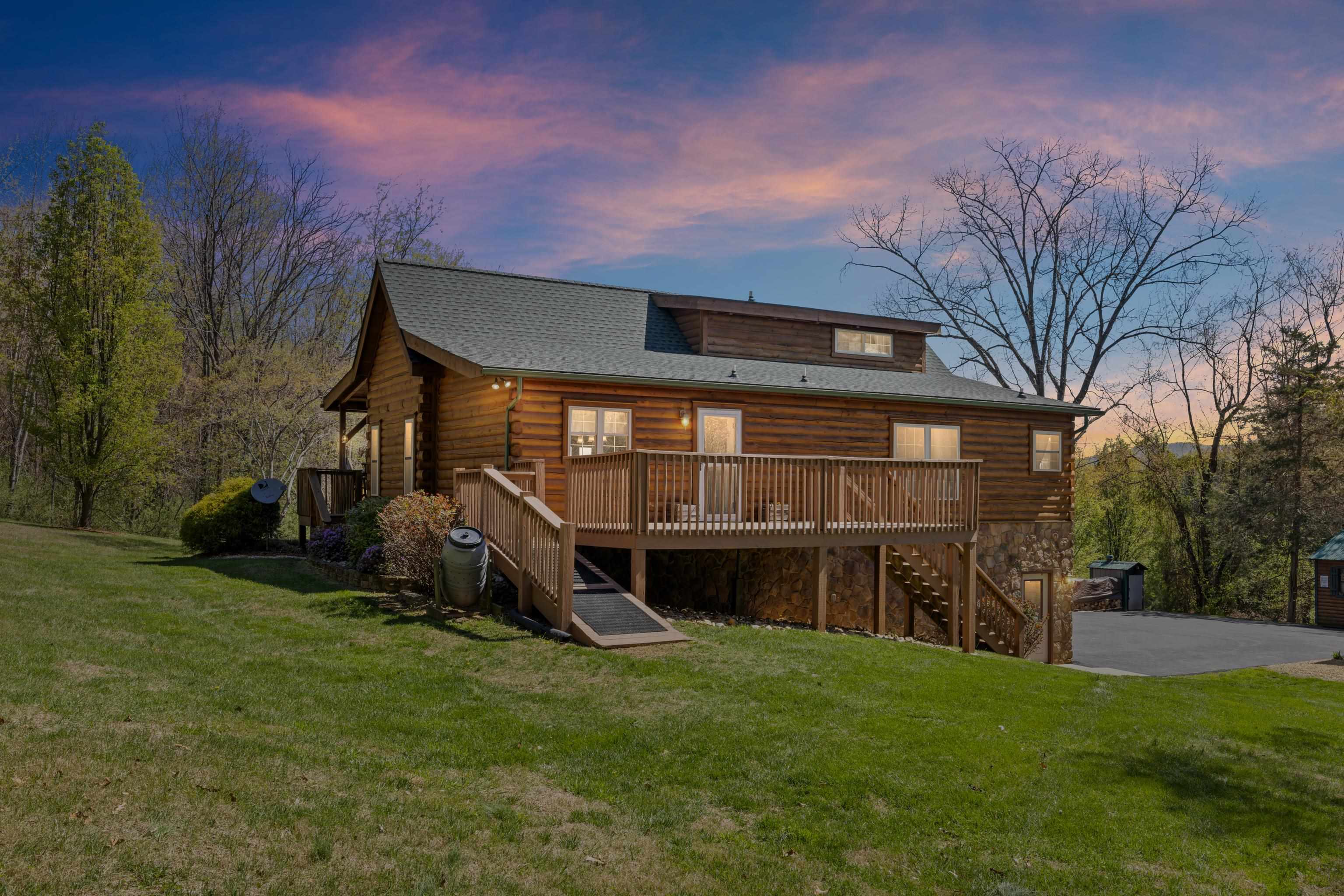 115 Spring Crossing Lane Steeles Tavern, VA 24476 - Photo 52 of 74 a view of a backyard with a large tree