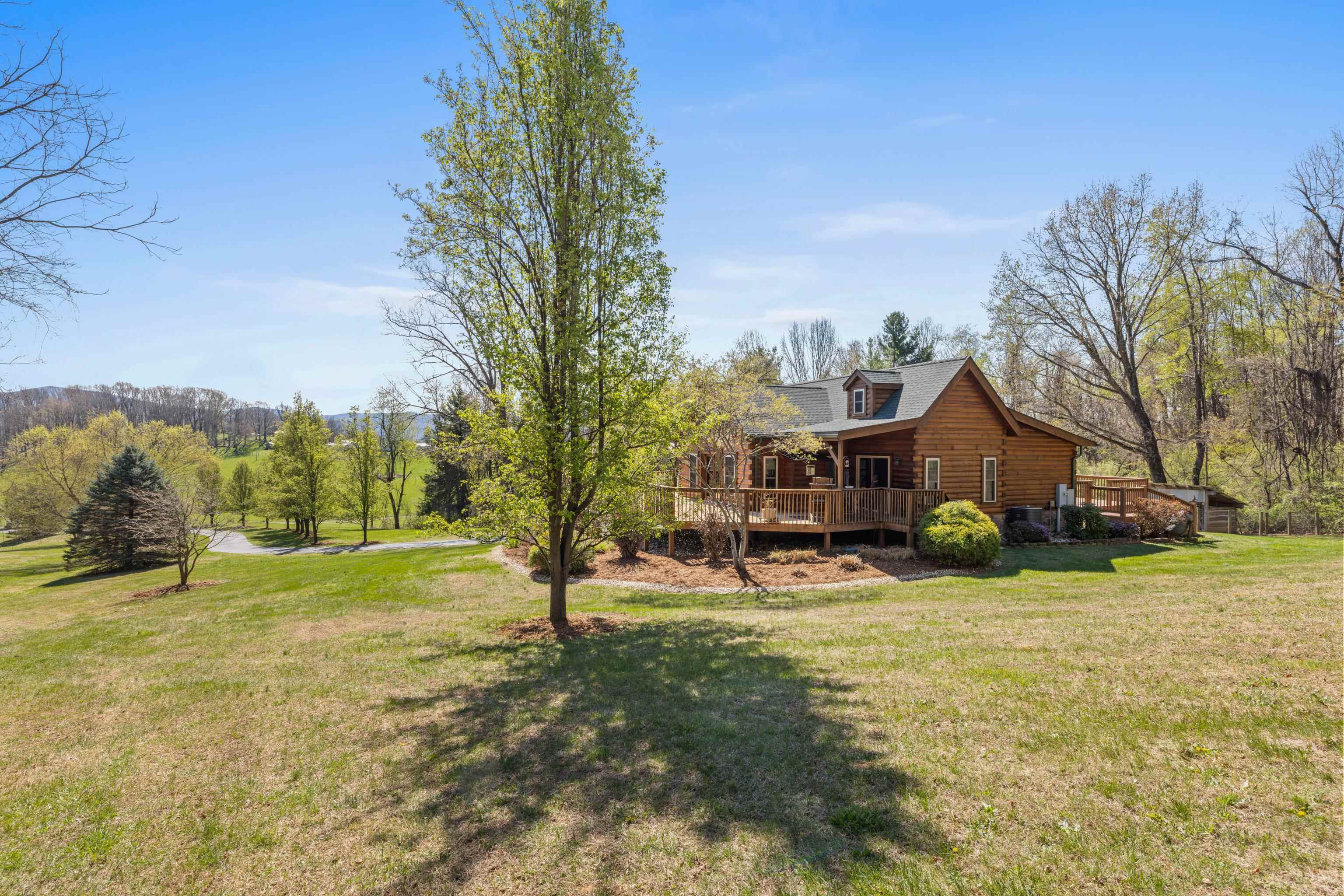 115 Spring Crossing Lane Steeles Tavern, VA 24476 - Photo 58 of 74 a view of a house with a yard