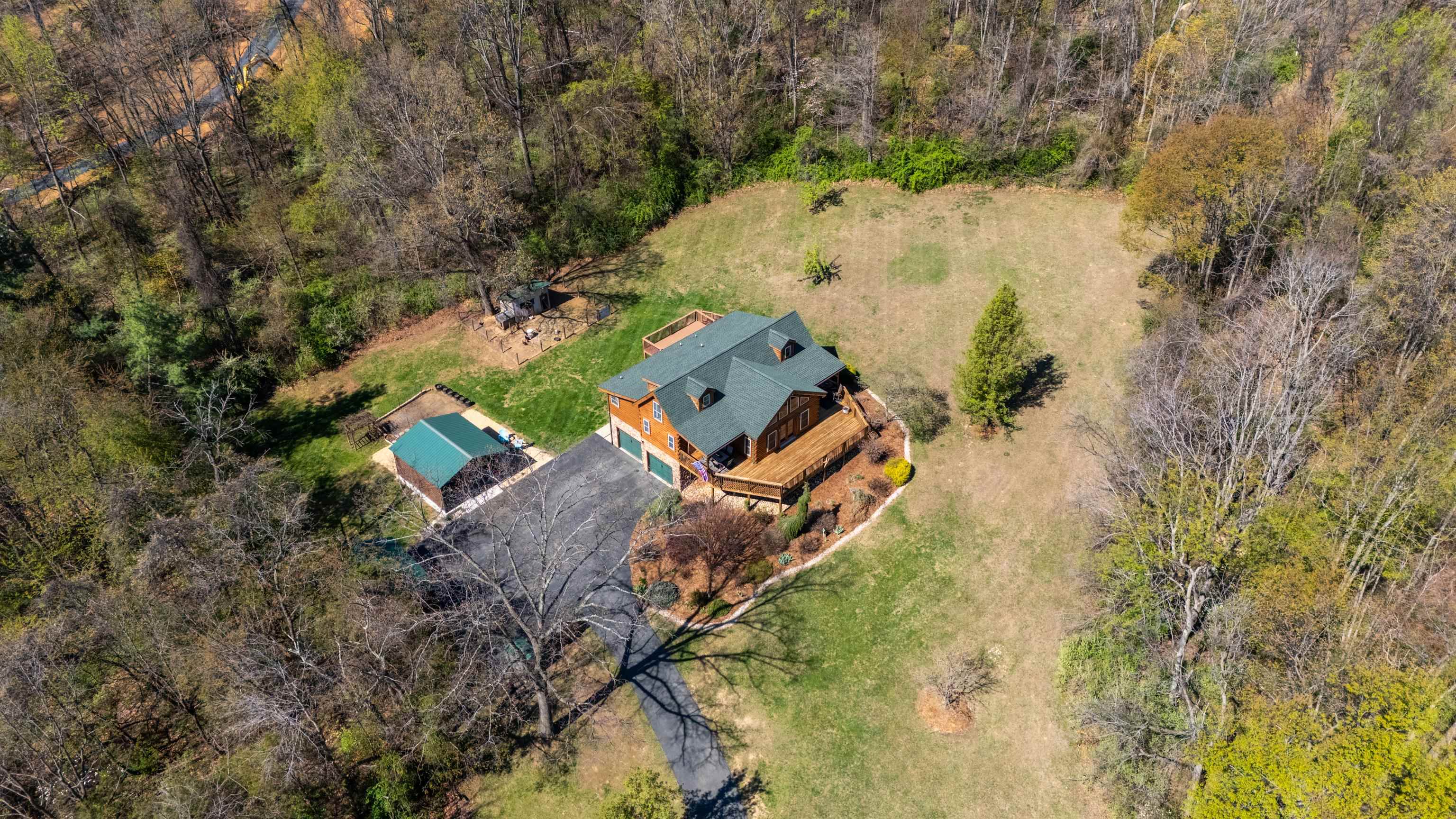 115 Spring Crossing Lane Steeles Tavern, VA 24476 - Photo 65 of 74 an aerial view of a house with a yard and trees