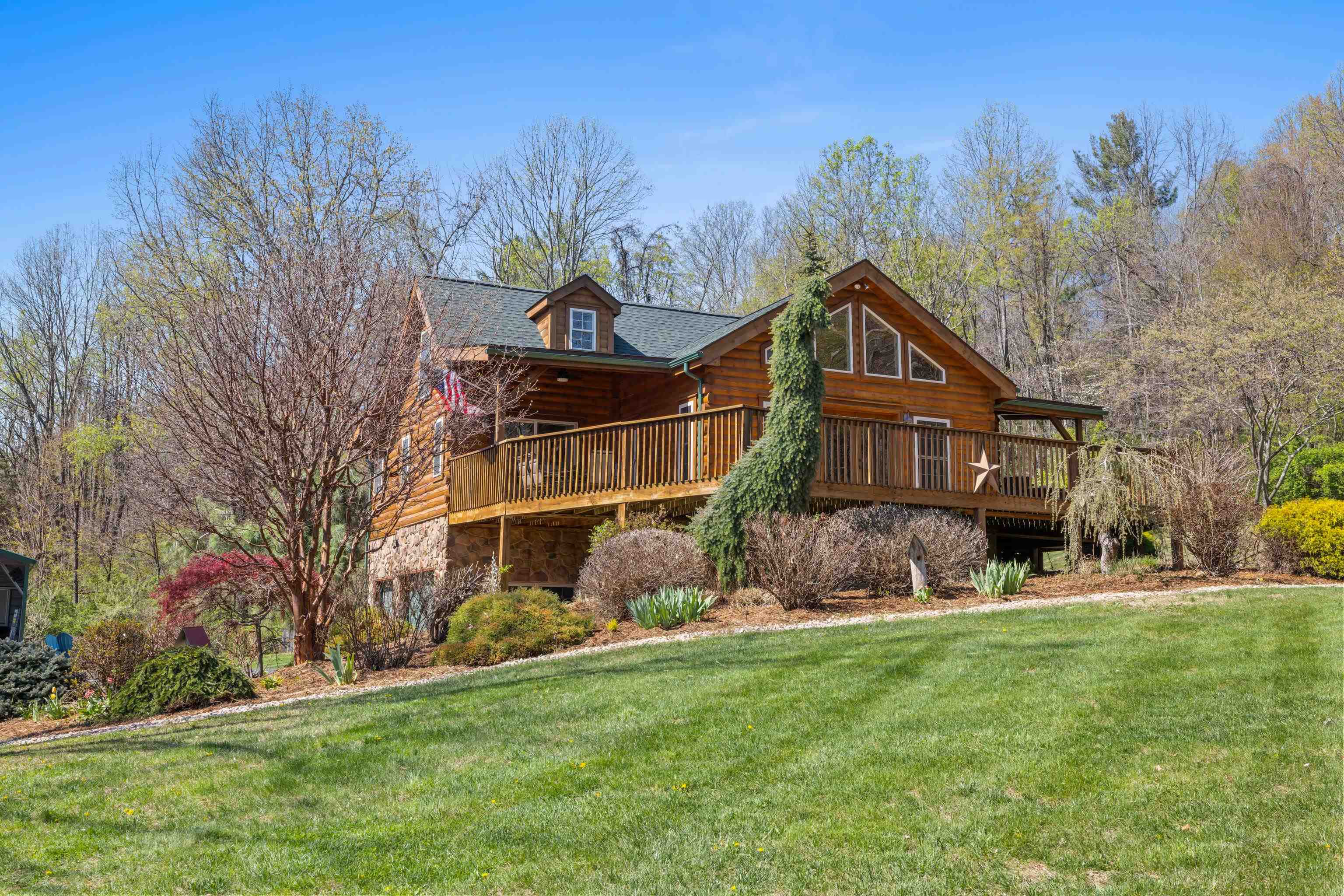 115 Spring Crossing Lane Steeles Tavern, VA 24476 - Photo 8 of 74 a front view of a house with a garden