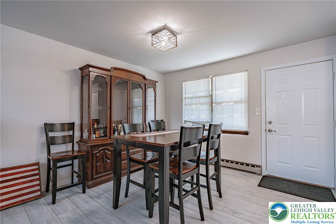 25 North 8th Street Emmaus, PA 18049 - Photo 9 of 51 Dining area featuring a practical breakfast bar and natural light through large windows.