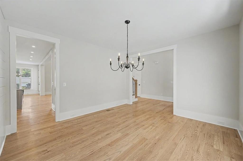 217 Laura Lake Road Marietta, GA 30066 - Photo 9 of 54 a view of a room with wooden floor a ceiling fan and kitchen space