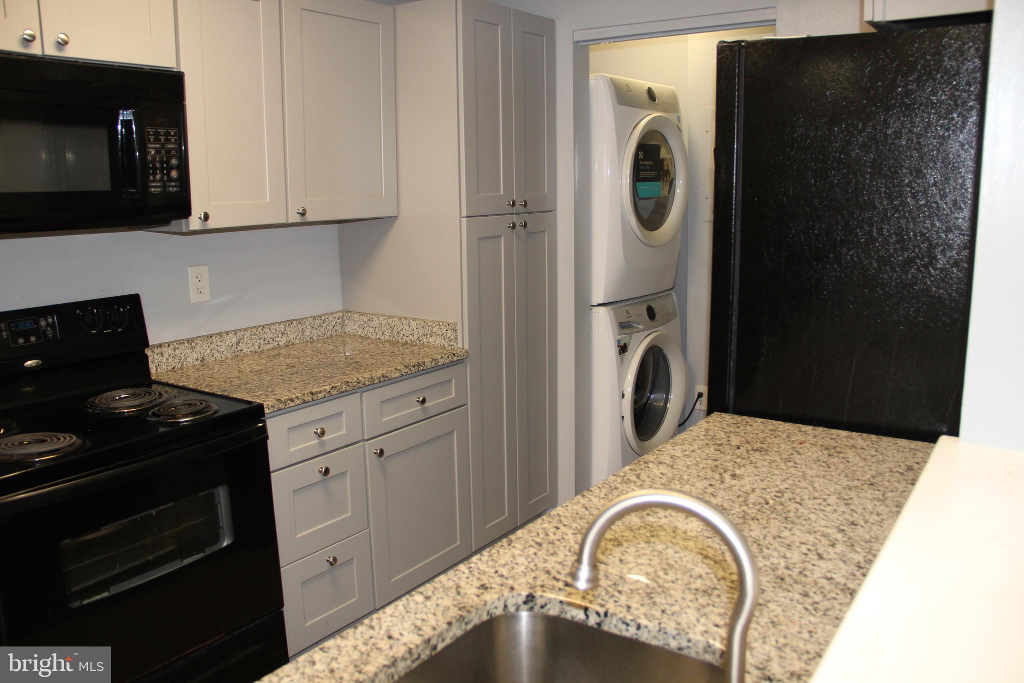 a view of a kitchen with washer and dryer