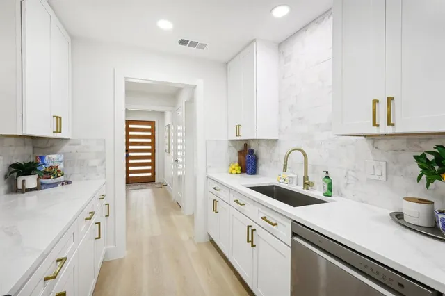 a kitchen with kitchen island a stove a sink and a refrigerator
