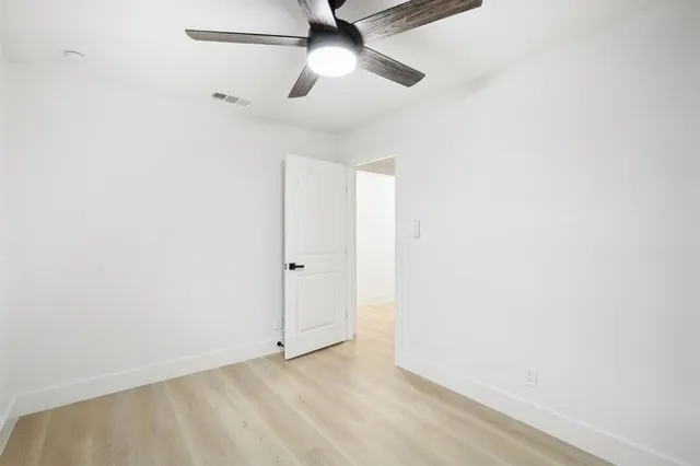 a kitchen with appliances cabinets table and chairs