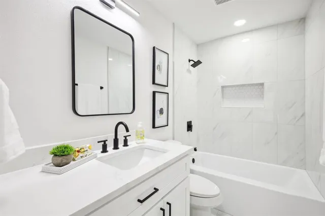 an empty room with a ceiling fan and wooden floor
