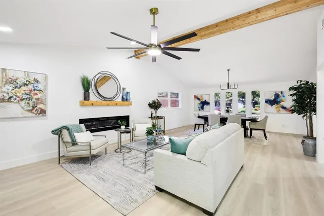 a living room with furniture a fireplace and a window