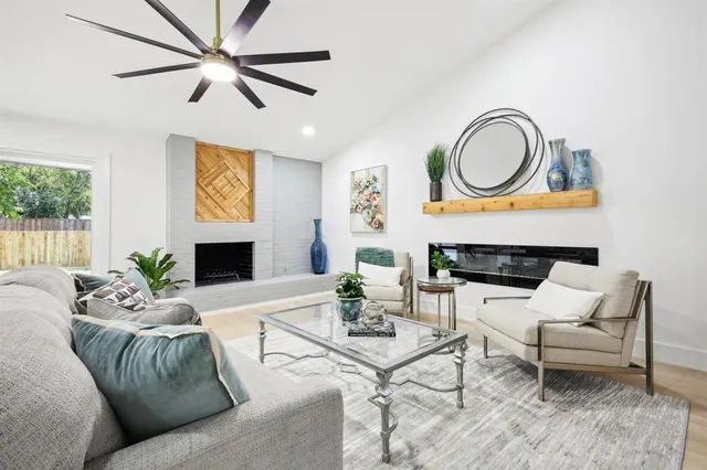 a living room with furniture a fireplace and a flat screen tv
