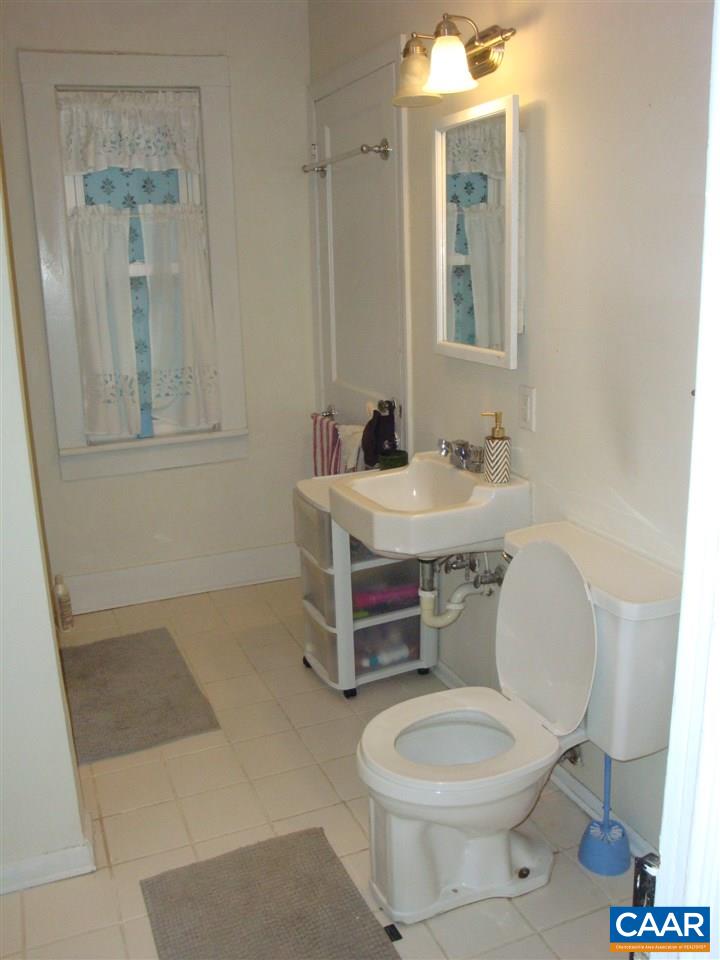 406 Harris Road Charlottesville, VA 22903 - Photo 7 of 13 a bathroom with a toilet a sink a mirror and vanity