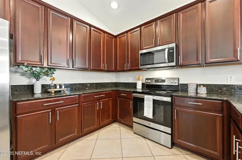 an aerial view of a house with a yard and mountain view