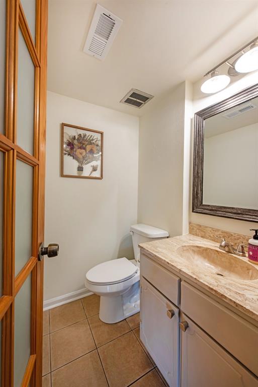 3 Surry County Place Northwest Atlanta, GA 30318 - Photo 16 of 50 a bathroom with a granite countertop sink toilet and mirror
