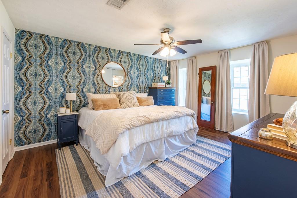 3 Surry County Place Northwest Atlanta, GA 30318 - Photo 19 of 50 a bedroom with a bed and a chandelier