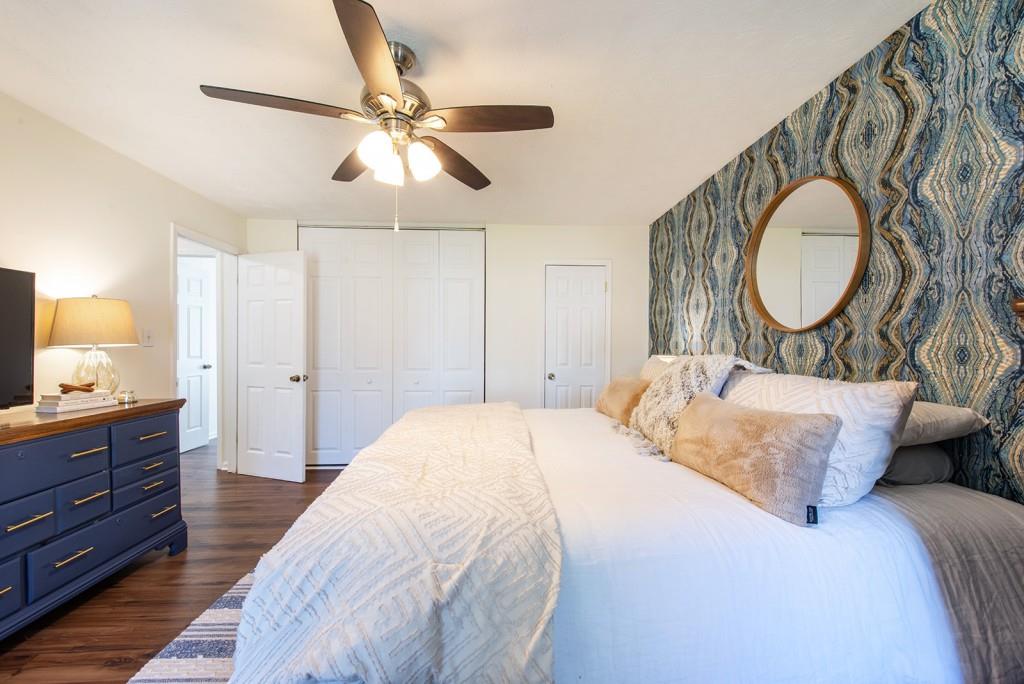 3 Surry County Place Northwest Atlanta, GA 30318 - Photo 21 of 50 a bedroom with a large bed and a chandelier