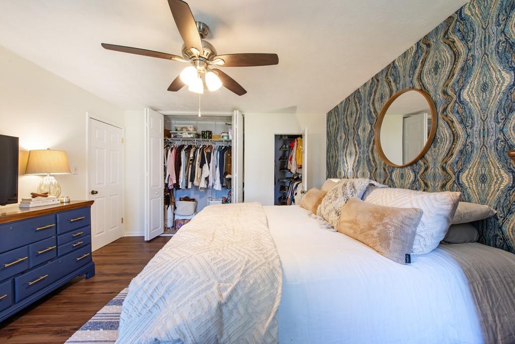 3 Surry County Place Northwest Atlanta, GA 30318 - Photo 22 of 50 a bedroom with a large bed and a chandelier