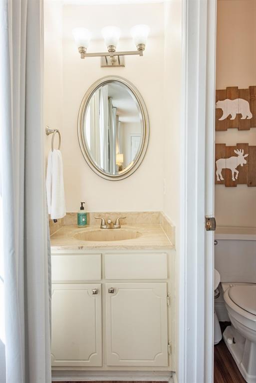 3 Surry County Place Northwest Atlanta, GA 30318 - Photo 29 of 50 a bathroom with a sink a toilet and a mirror