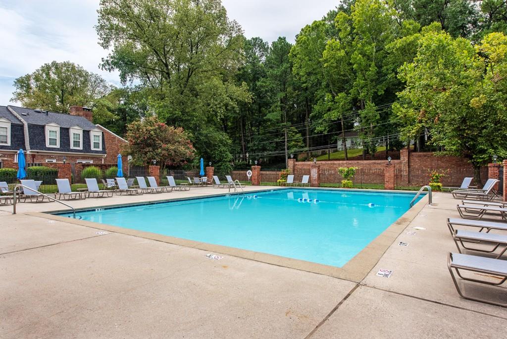 3 Surry County Place Northwest Atlanta, GA 30318 - Photo 44 of 50 a view of swimming pool with outdoor seating and trees in the background