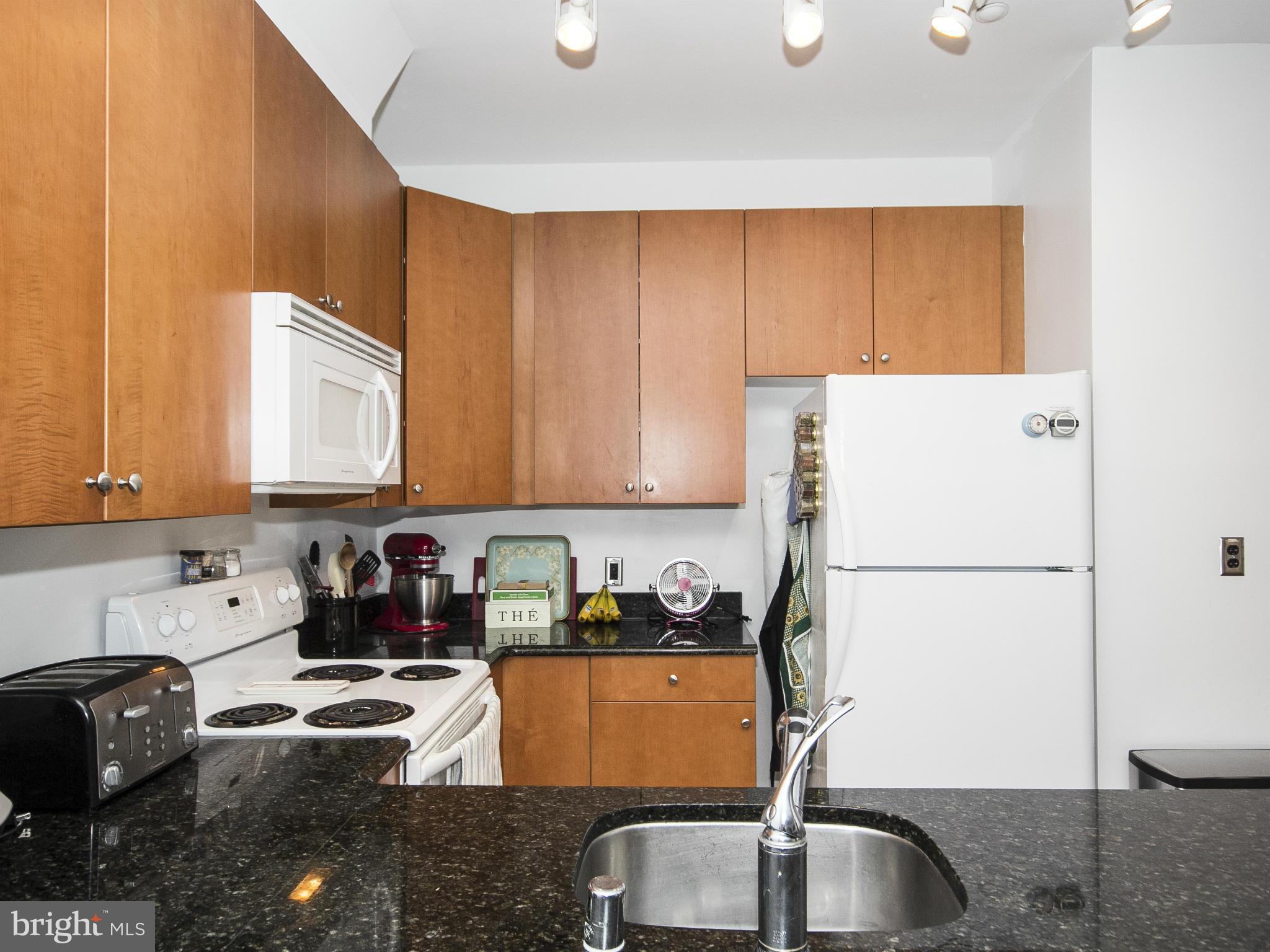 2007 Clipper Park Road, Unit 116 Baltimore, MD 21211 - Photo 2 of 30 a kitchen with a sink a stove and a refrigerator