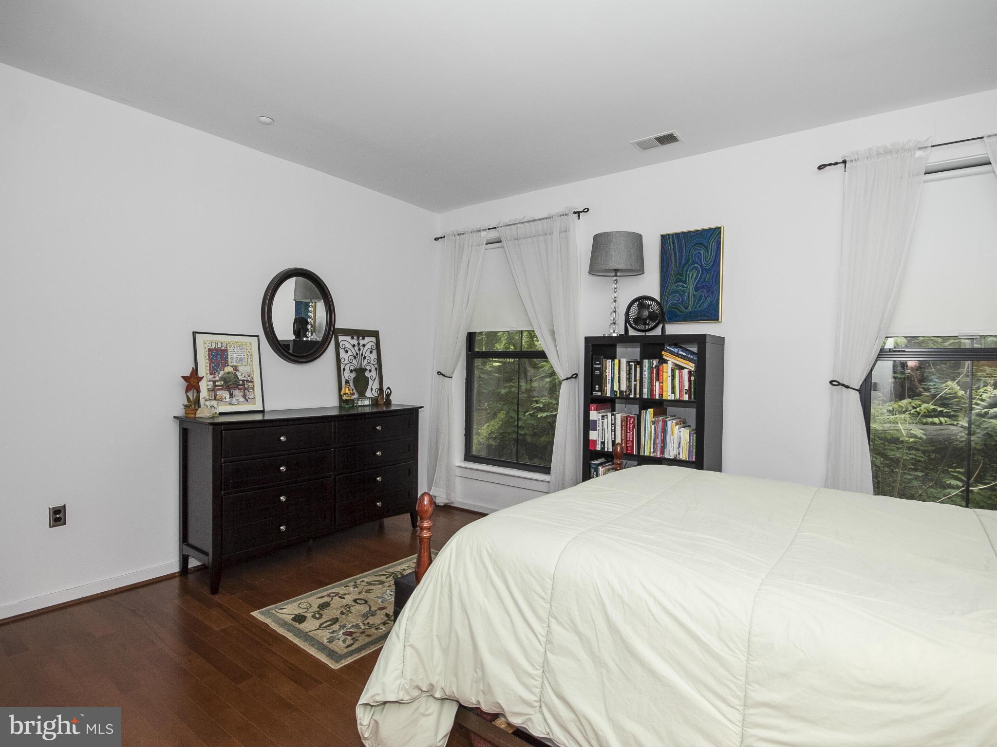 2007 Clipper Park Road, Unit 116 Baltimore, MD 21211 - Photo 11 of 30 a bedroom with a bed and a dresser