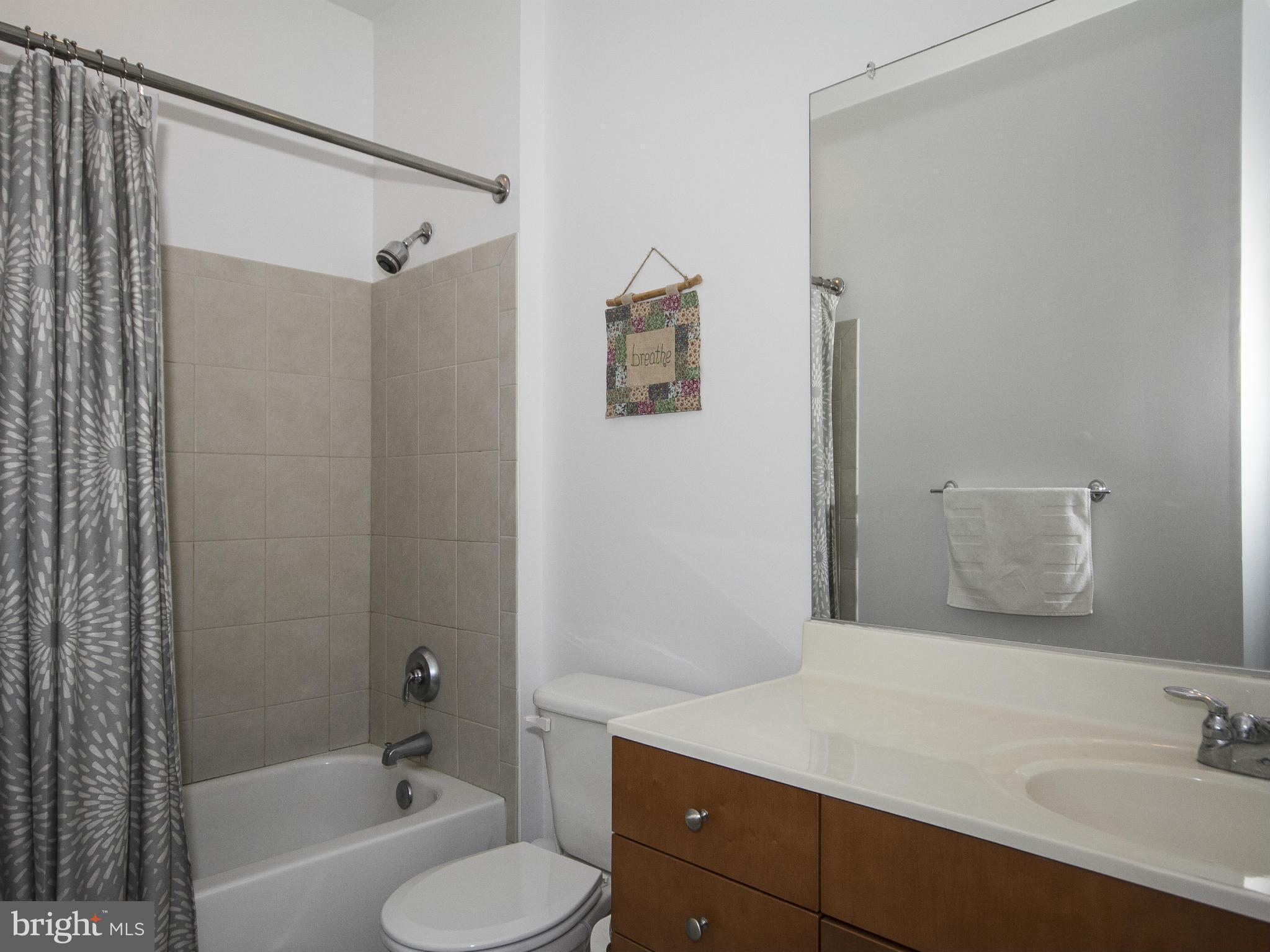 2007 Clipper Park Road, Unit 116 Baltimore, MD 21211 - Photo 13 of 30 a bathroom with a sink toilet tub and shower