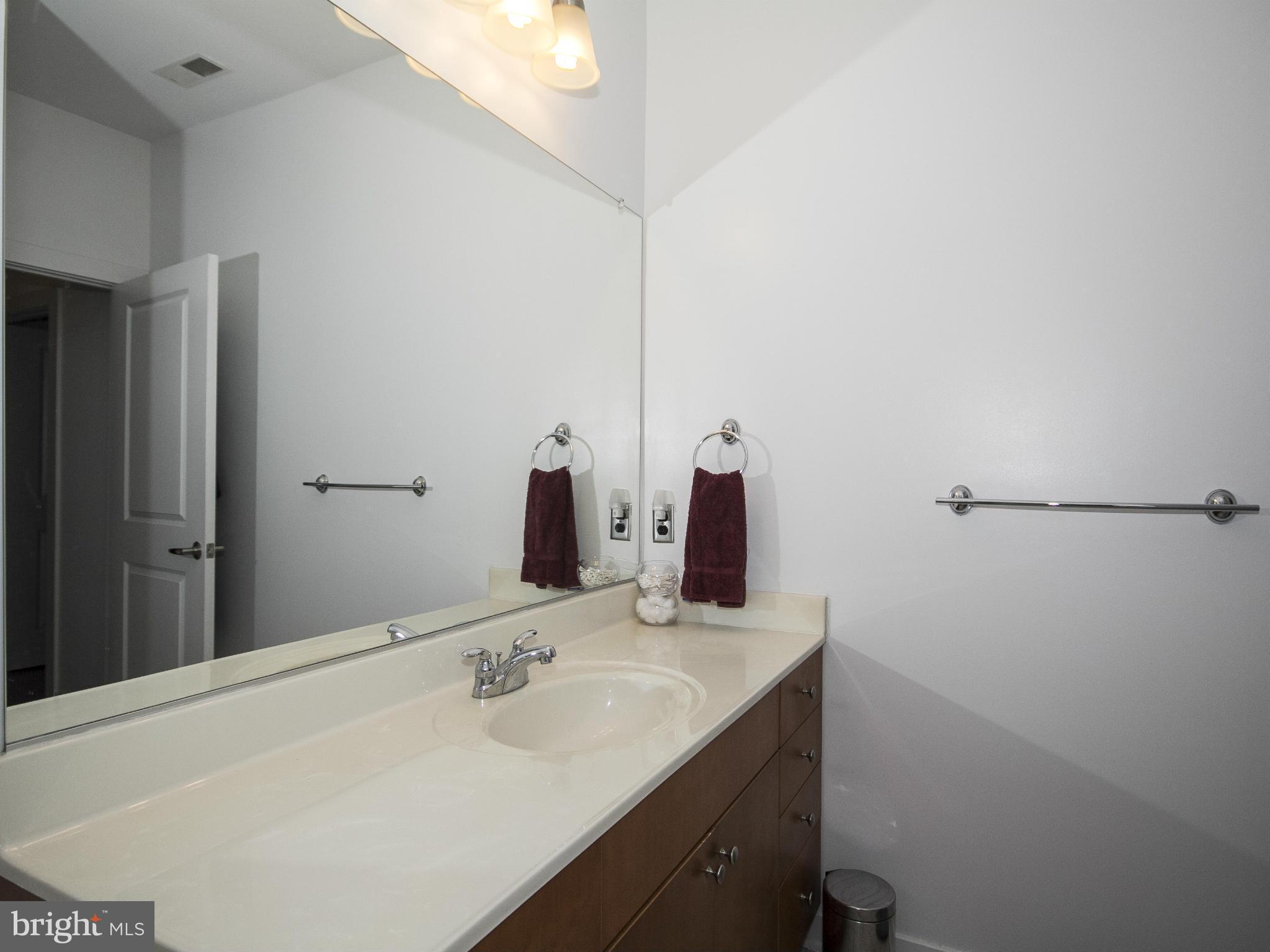 2007 Clipper Park Road, Unit 116 Baltimore, MD 21211 - Photo 14 of 30 a bathroom with a sink and mirror