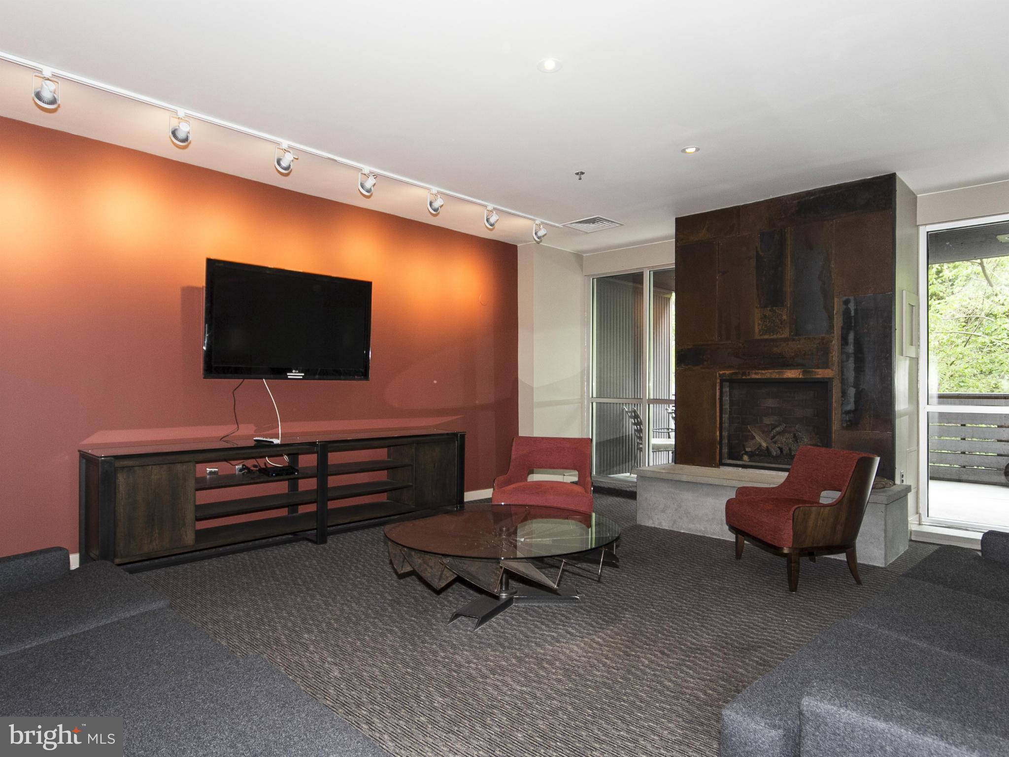 2007 Clipper Park Road, Unit 116 Baltimore, MD 21211 - Photo 17 of 30 a living room with furniture and a flat screen tv