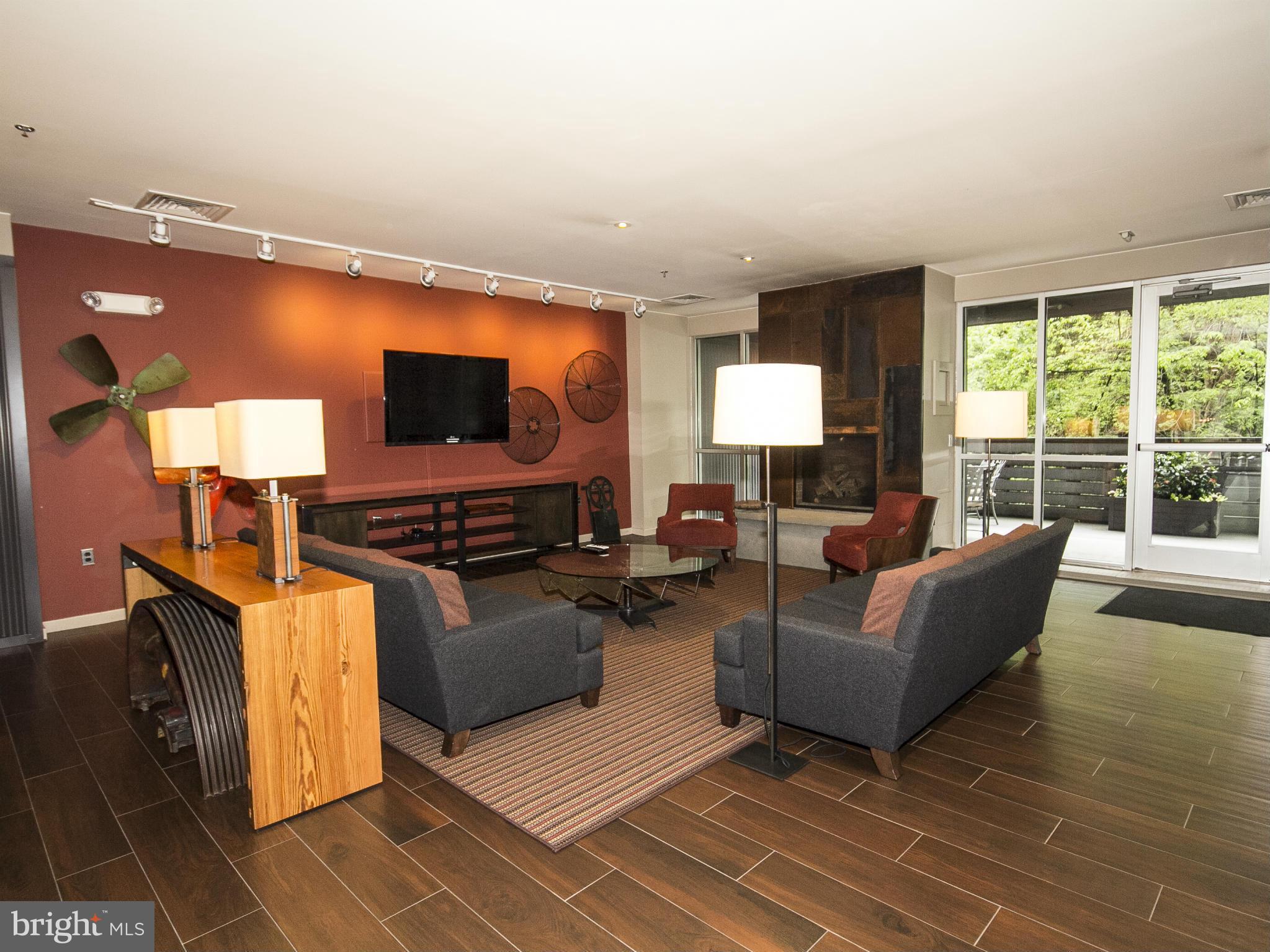 2007 Clipper Park Road, Unit 116 Baltimore, MD 21211 - Photo 18 of 30 a living room with furniture and a flat screen tv