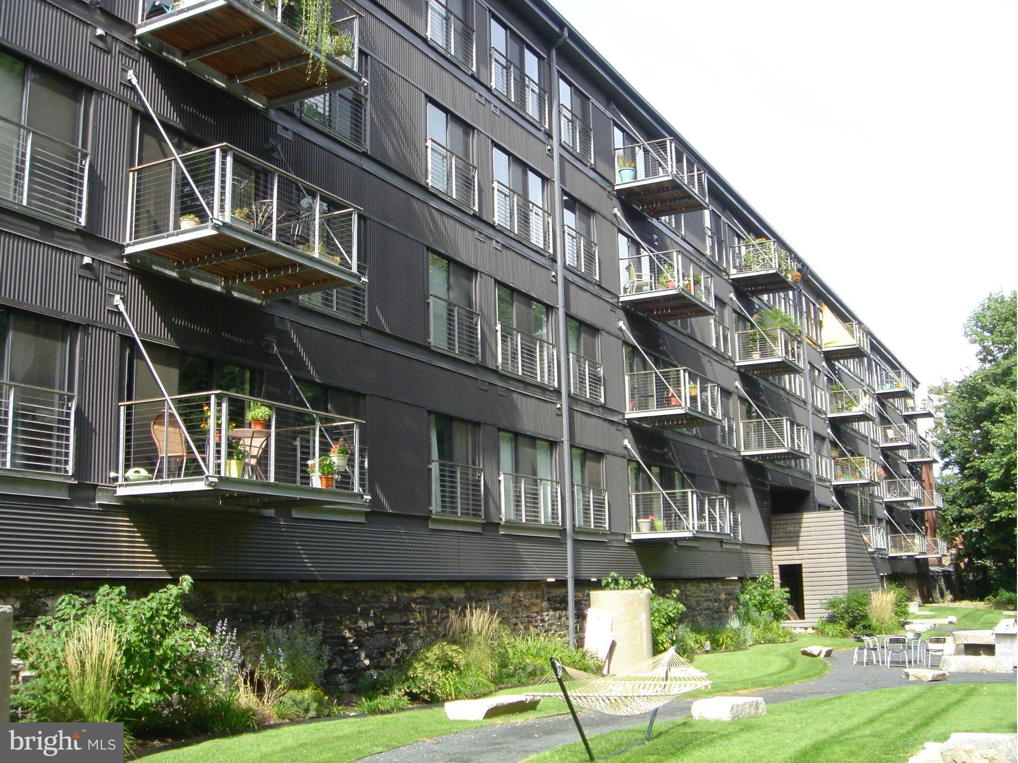 2007 Clipper Park Road, Unit 116 Baltimore, MD 21211 - Photo 20 of 30 a front view of a building with a garden
