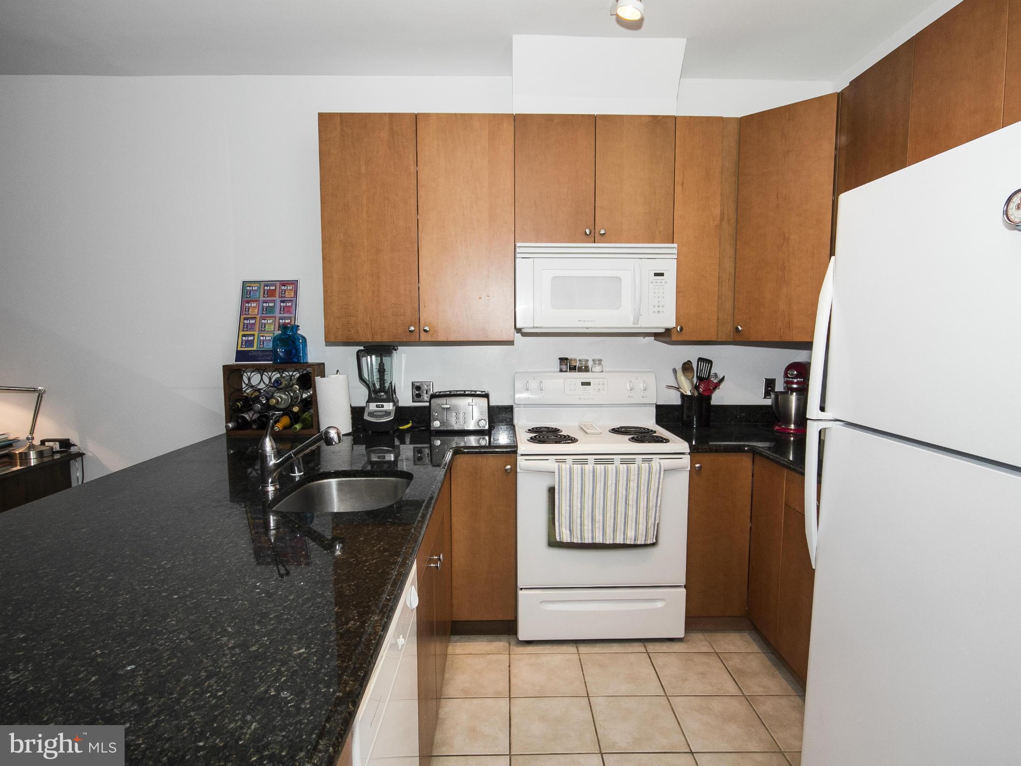 2007 Clipper Park Road, Unit 116 Baltimore, MD 21211 - Photo 4 of 30 a kitchen with a refrigerator and a stove