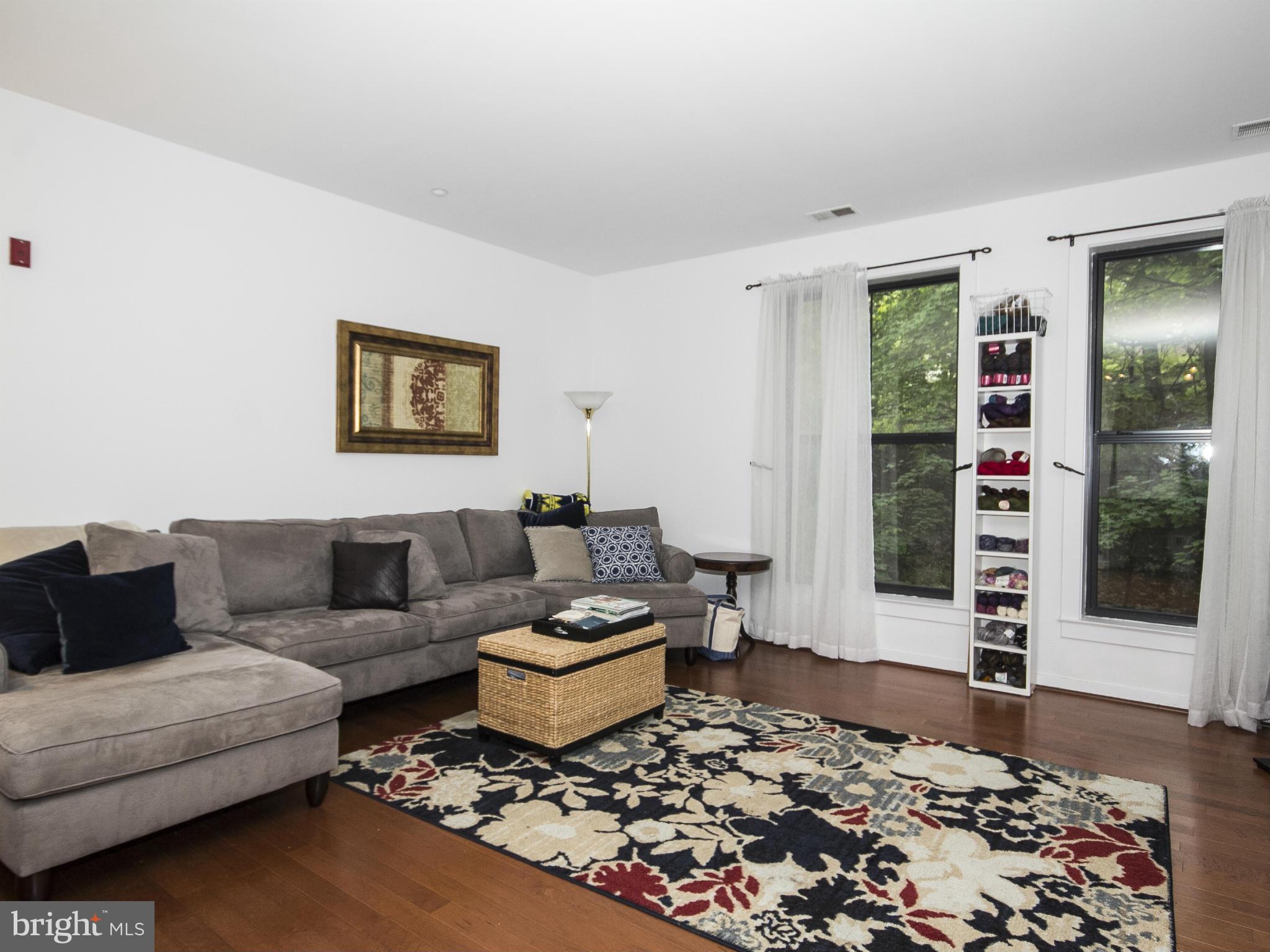 2007 Clipper Park Road, Unit 116 Baltimore, MD 21211 - Photo 5 of 30 a living room with furniture and wooden floor