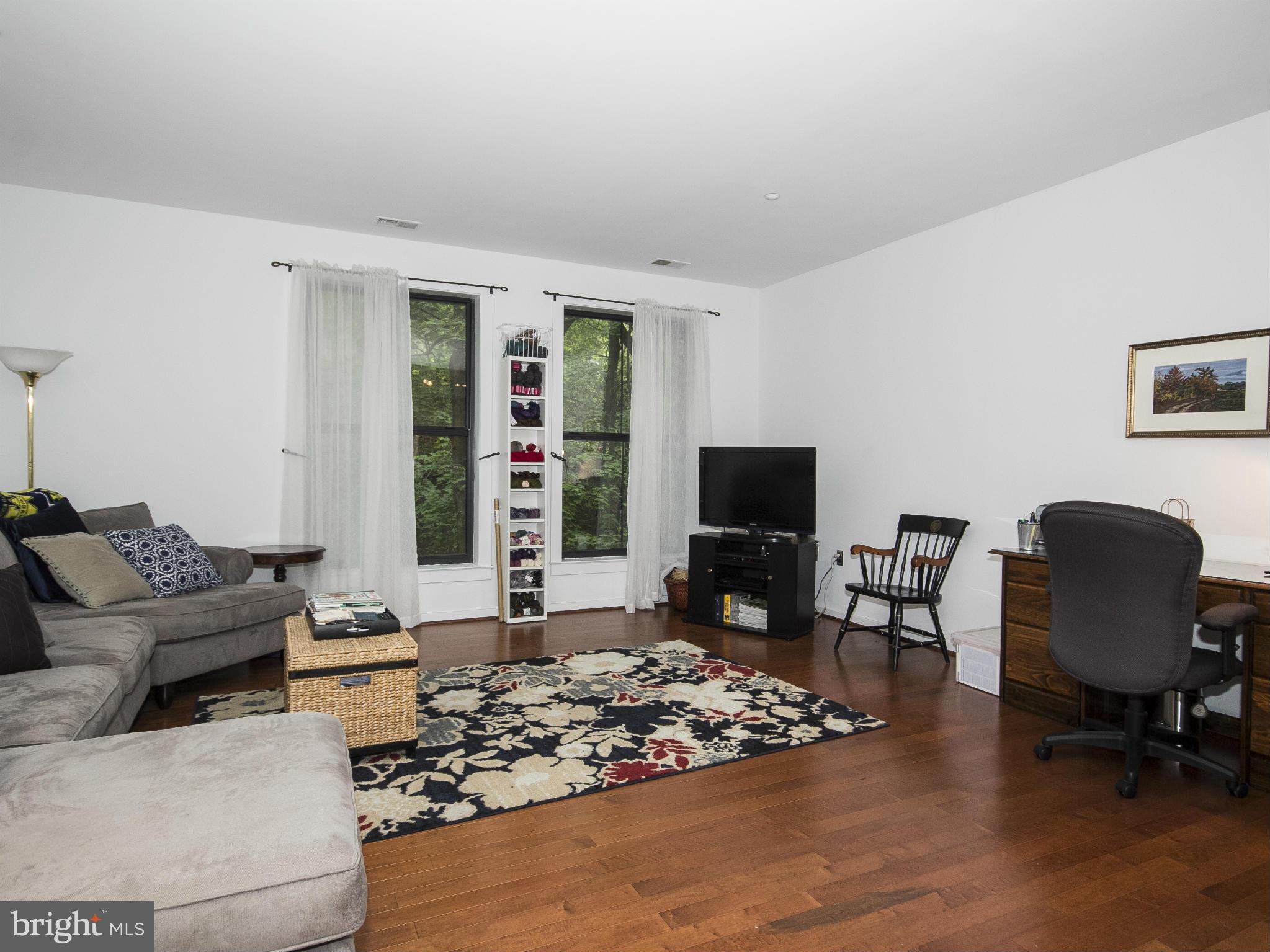 2007 Clipper Park Road, Unit 116 Baltimore, MD 21211 - Photo 6 of 30 a living room with furniture and a flat screen tv