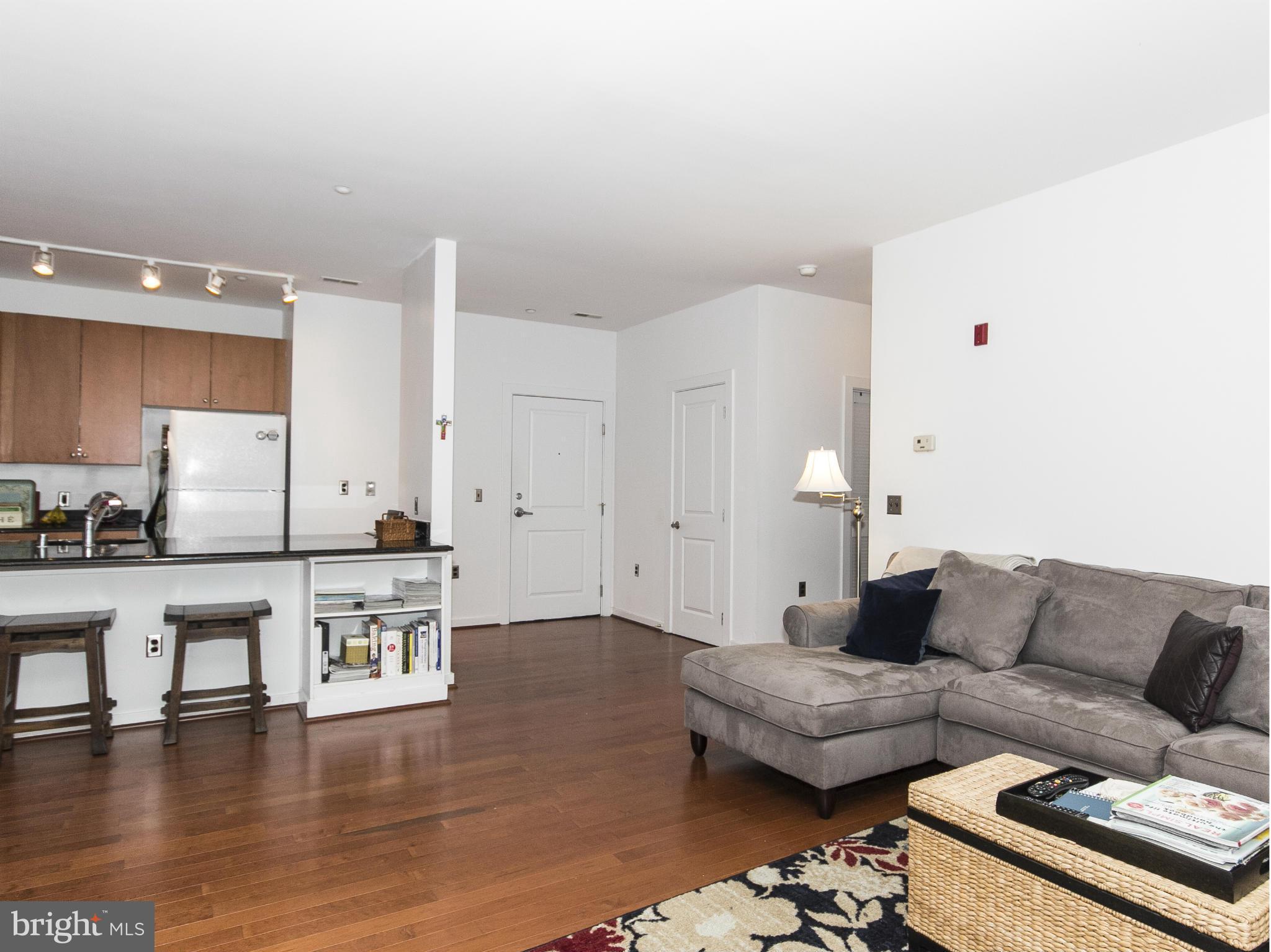 2007 Clipper Park Road, Unit 116 Baltimore, MD 21211 - Photo 8 of 30 a living room with furniture and wooden floor
