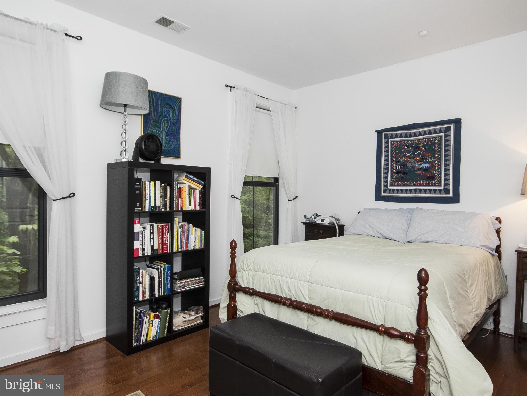 2007 Clipper Park Road, Unit 116 Baltimore, MD 21211 - Photo 10 of 30 a bedroom with a bed and a book shelf