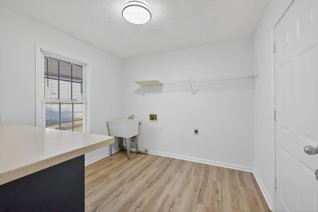 a view of a room with wooden floor and cabinet
