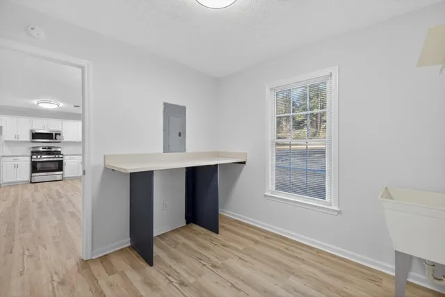 a view of kitchen with windows and refrigerator