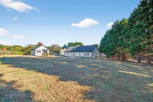 a view of a house with a yard
