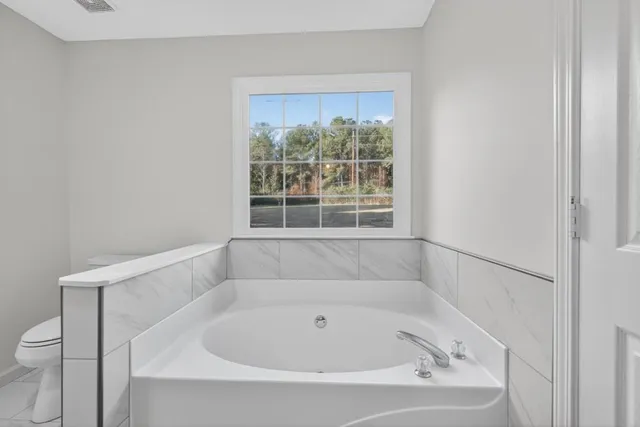 a white bath tub sitting next to a window