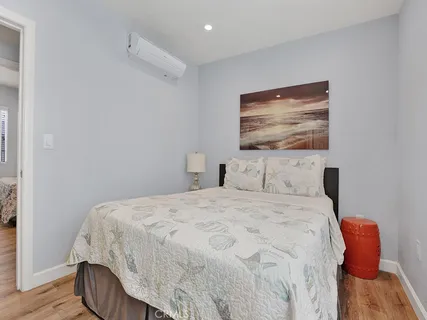 a bedroom with a bed and painting on the wall