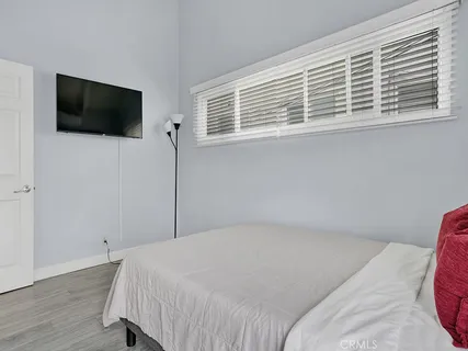 a bedroom with a bed and a flat screen tv