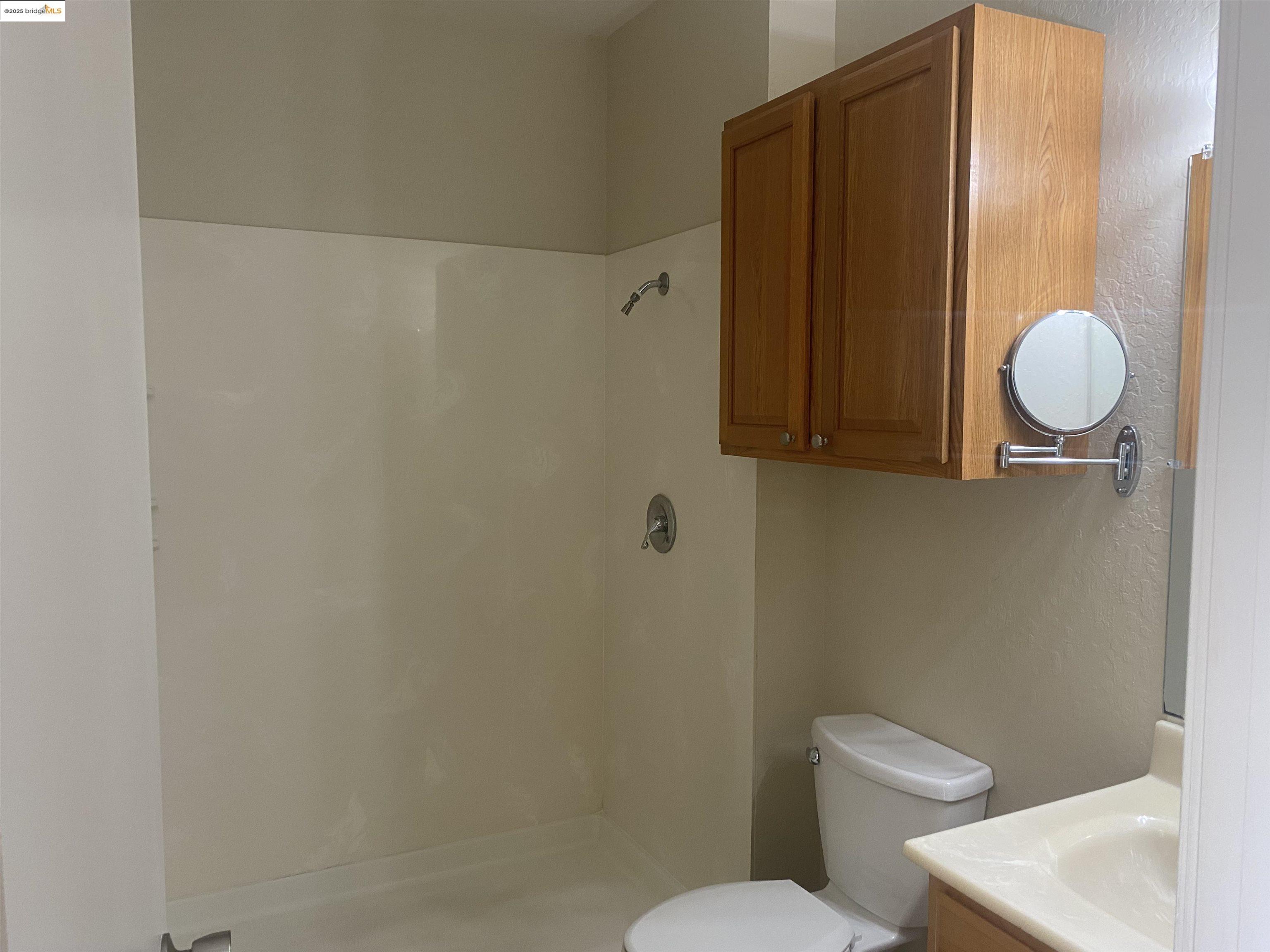 1887 Farm Bureau Road, Unit B Concord, CA 94519 - Photo 7 of 8 a white toilet sitting next to a bathroom sink