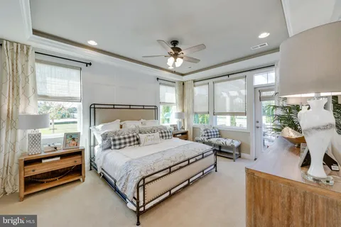 a bedroom with a bed couch and a window