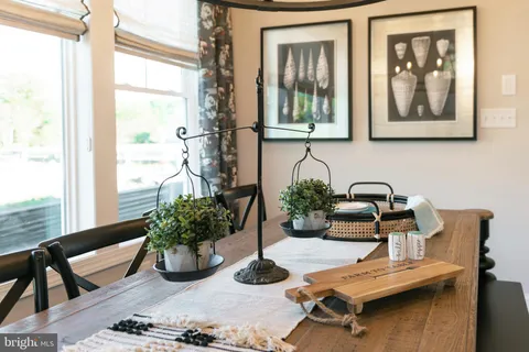 a dining room with furniture and wooden floor